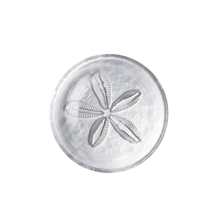 White ceramic plate with embossed sand dollar design in center, viewed from above.
