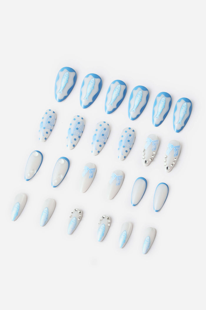 Almond press-on nails with blue fish and polka dot designs