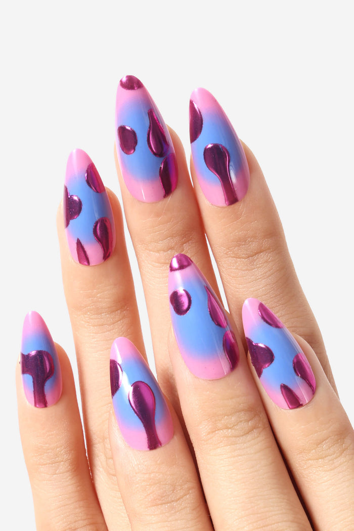 Press-on nails with a pink and blue gradient base, featuring metallic purple lava lamp shapes.