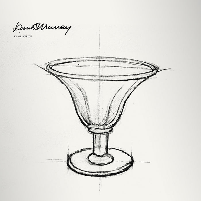 Hand-drawn sketch of a pedestal dessert bowl with wide rim and footed base, labeled "Donna Murray VP of Design."