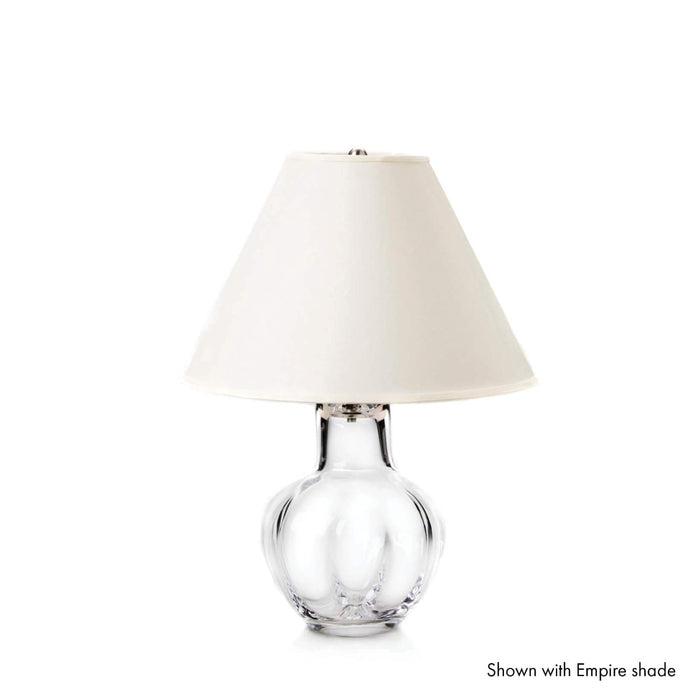 Clear glass bulbous base with cream linen empire shade and polished nickel fittings.