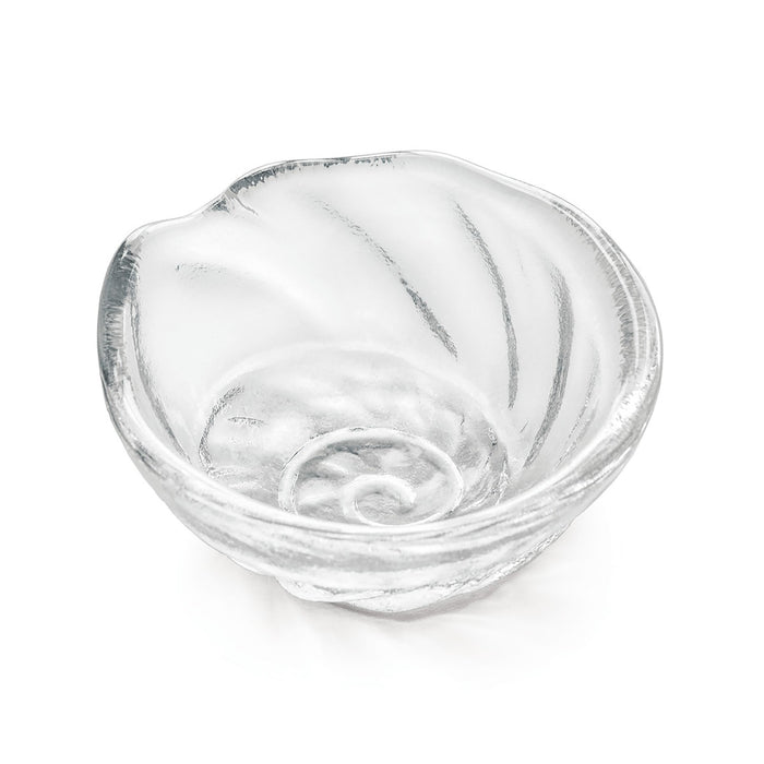 Small clear glass bowl with shell-shaped form and curved ridged surface detail.