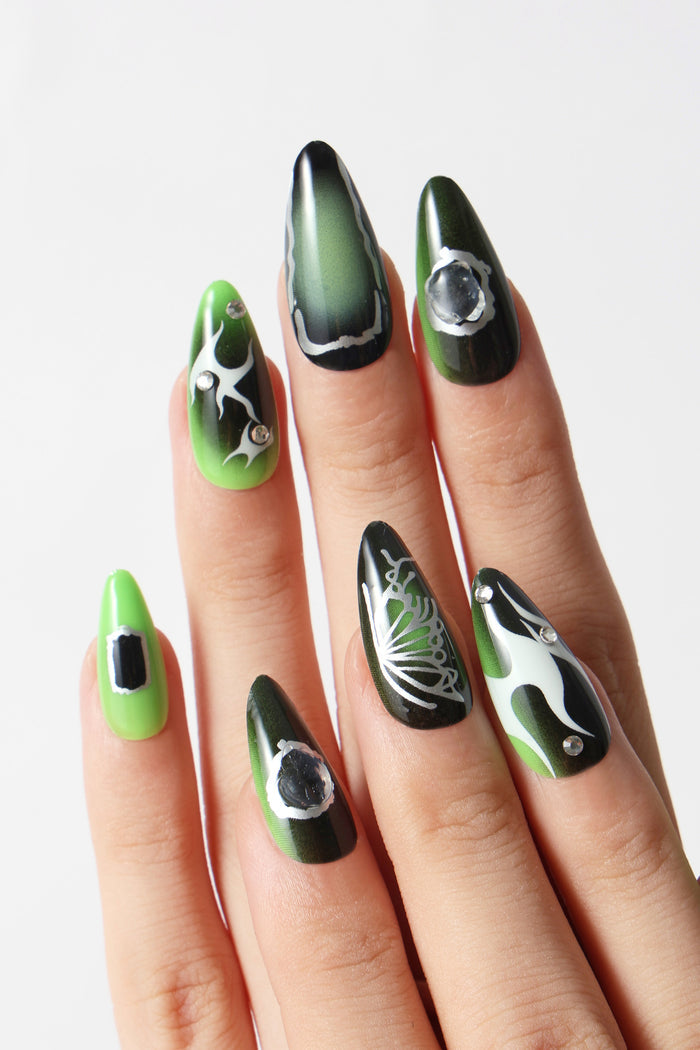 SHE'S A BRAT press-on nails: green gradient, silver flame and butterfly art, rhinestones.