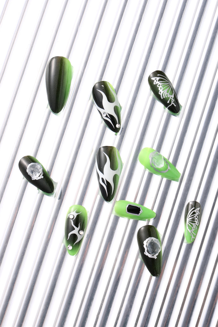 SHE'S A BRAT press-on nails feature flame and butterfly designs in green and black.