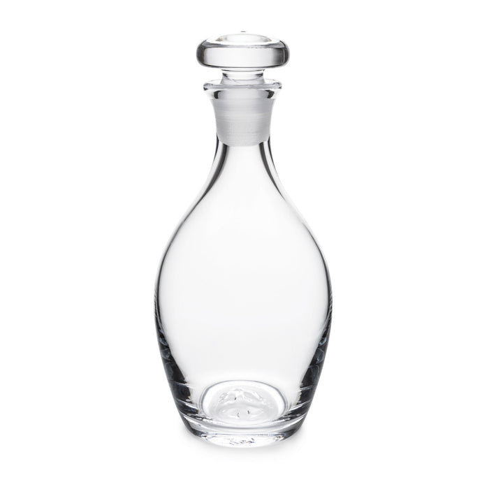 Clear glass decanter with rounded body, narrow neck, and matching glass stopper with flat top.