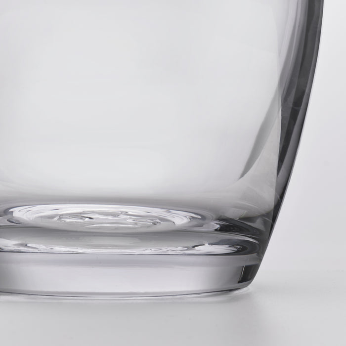Clear glass decanter with curved body and wide base, shown from a side angle.