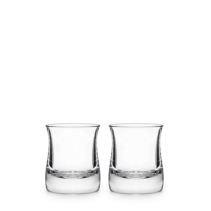 Two clear glass whiskey glasses with curved sides and weighted bases, each partially filled with clear liquid.