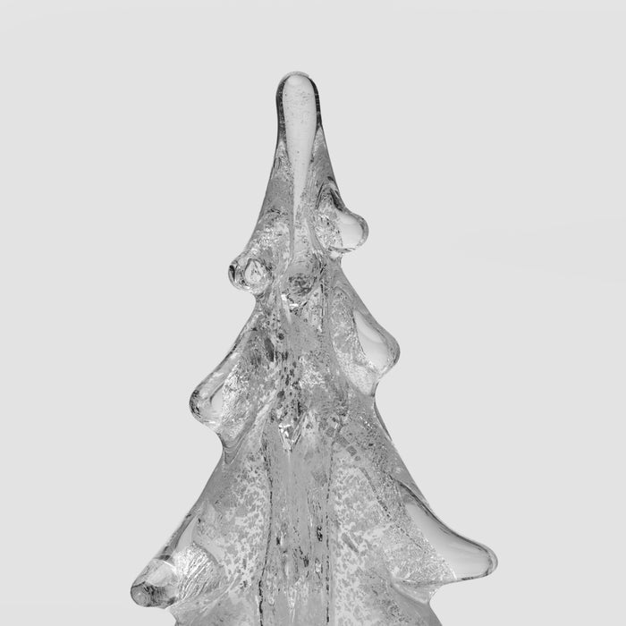 Clear glass evergreen tree figurine with silver-toned accents and textured surface details.