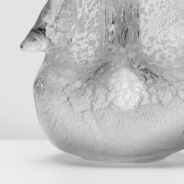 Silver textured ceramic or glass vessel with organic, leaf-like surface pattern and curved form.