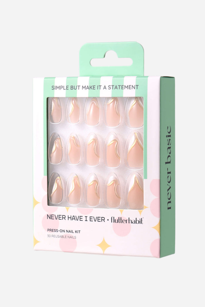 Short almond press-on nails: nude base, gold/white tips. Box says: SIMPLE BUT MAKE IT A STATEMENT, NEVER HAVE I EVER, flutterhabit.