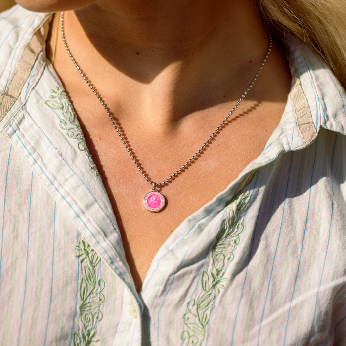 small fuchsia pink st. christopher on model neck