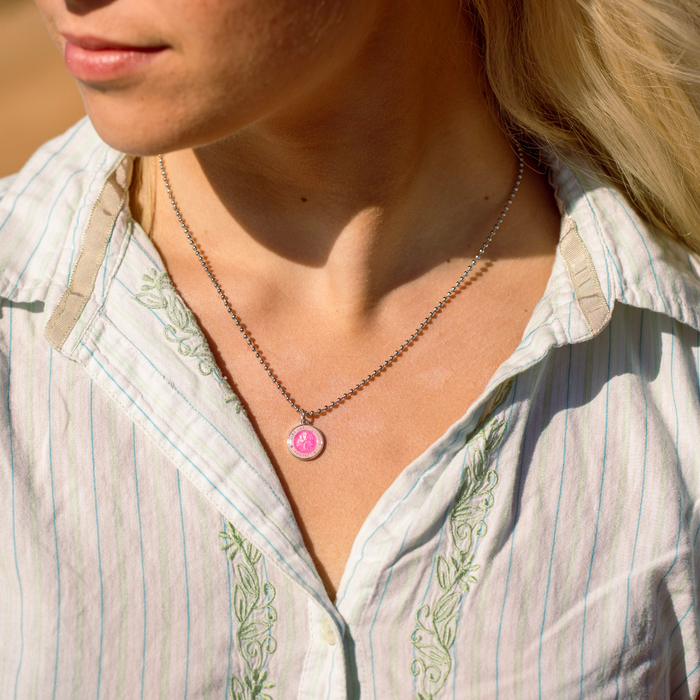 small fuchsia pink st. christopher on model neck