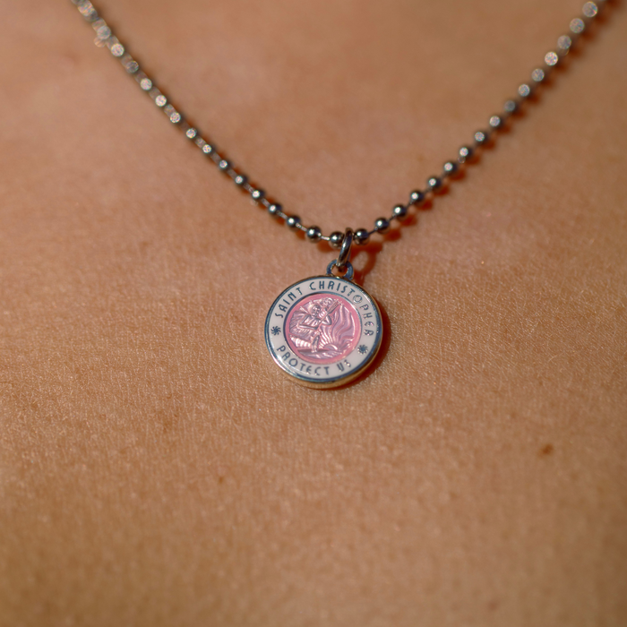 close of up of small pink white st. christopher
