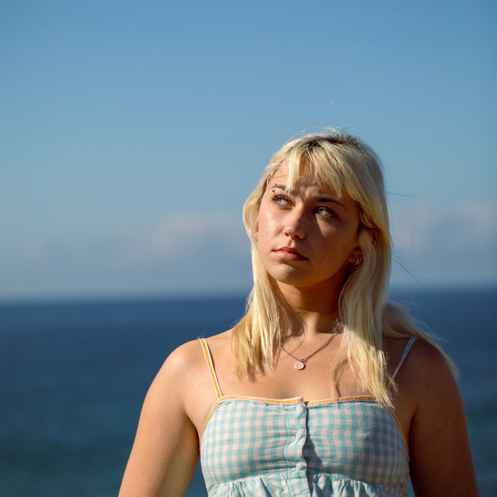 model wearing small pink white st. christopher