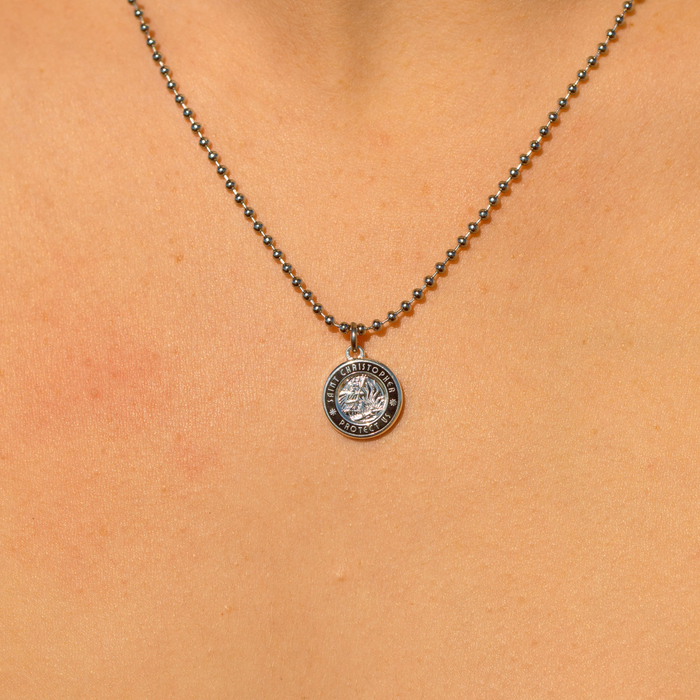 small silver black st. christopher close up on chest