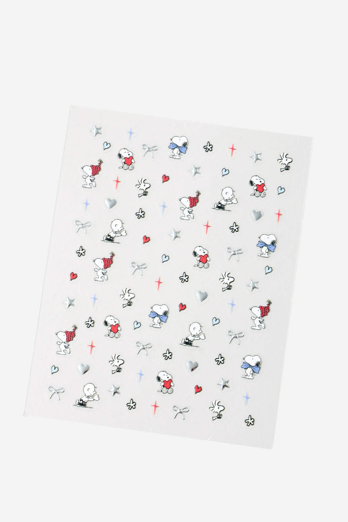 Sheet of Peanuts nail stickers featuring Snoopy and Woodstock designs, hearts, and stars.