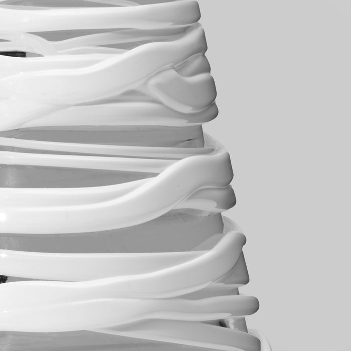 White conical tree decoration with layered, curved bands stacked to form a tapered tree shape.