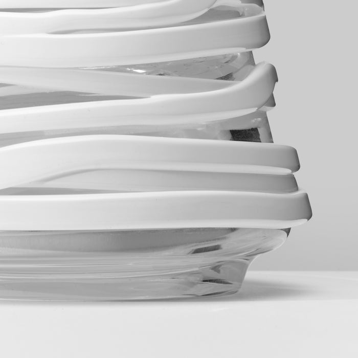 White conical tree decoration with layered curved bands and dark base, shown at an angle.