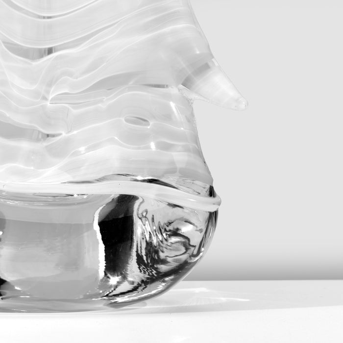Clear glass container with evergreen sprig etched on base, shown at angle against white background.