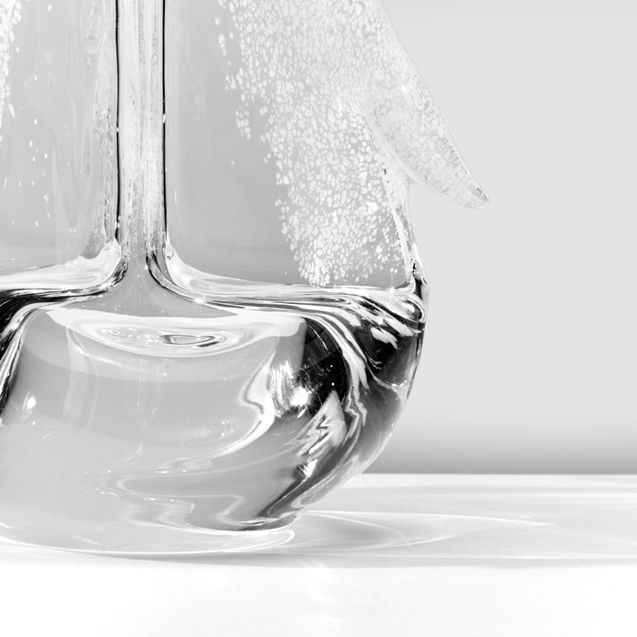 Clear glass vase with white frost-textured branch design against gray background.