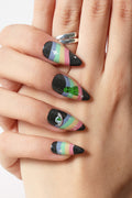 Ripndip stiletto press-on nails with black glitter and pastel rainbow design, featuring an alien and eye.