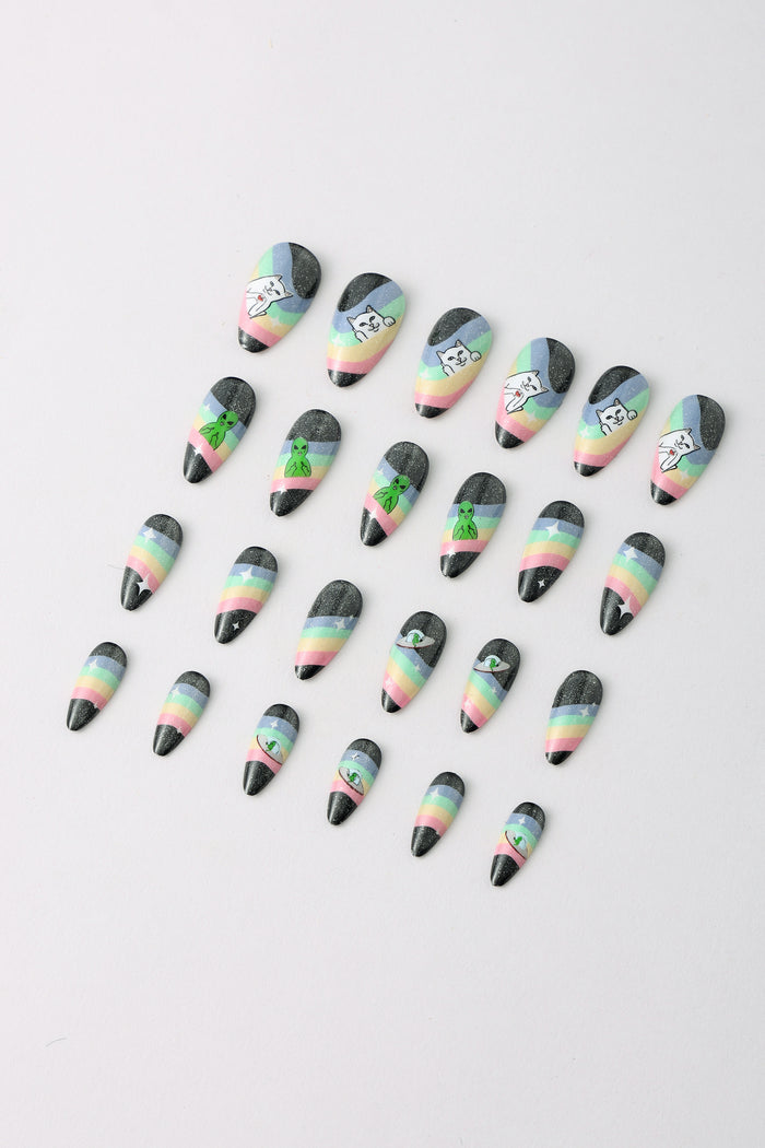 RIPNDIP SPACED OUT press-on nails featuring rainbow stripes and alien or cat graphics.