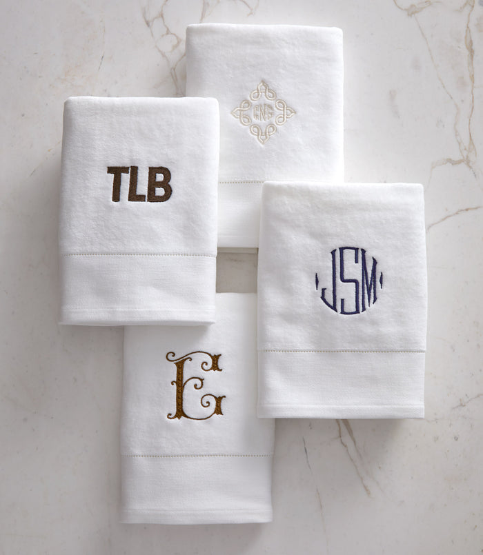 Four monogrammed Special Occasion Hand Towel lay flat