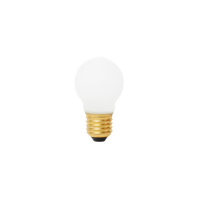 Matte white spherical LED bulb with brass screw base and black contact point.