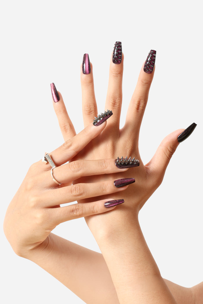 Spiked Out coffin press-on nails with deep wine glitter and metal studs.