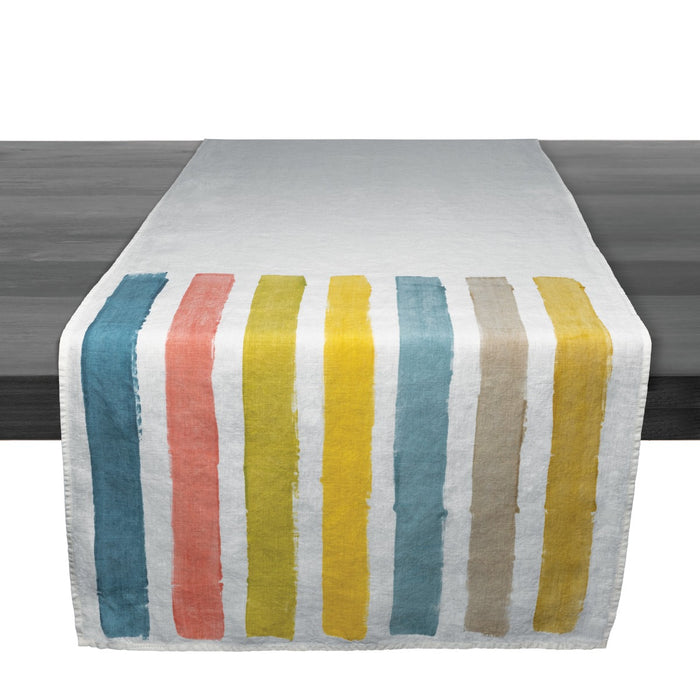 Linen table runner with vertical stripes in teal, coral, yellow, and beige on white background.