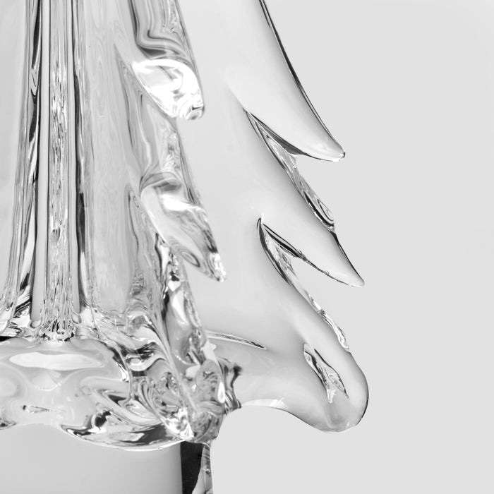 Clear glass sculpture with pointed leaf-like forms arranged vertically, shown in black and white.