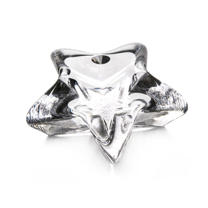 Clear glass star-shaped paperweight with pointed edges and a smooth, polished finish.