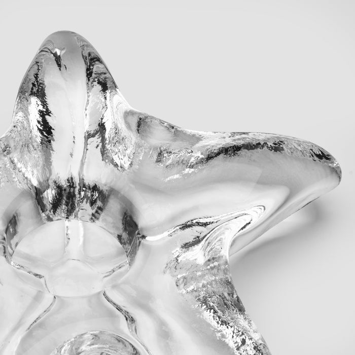 Silver-finished starfish-shaped tealight holder with textured surface and metallic accents.