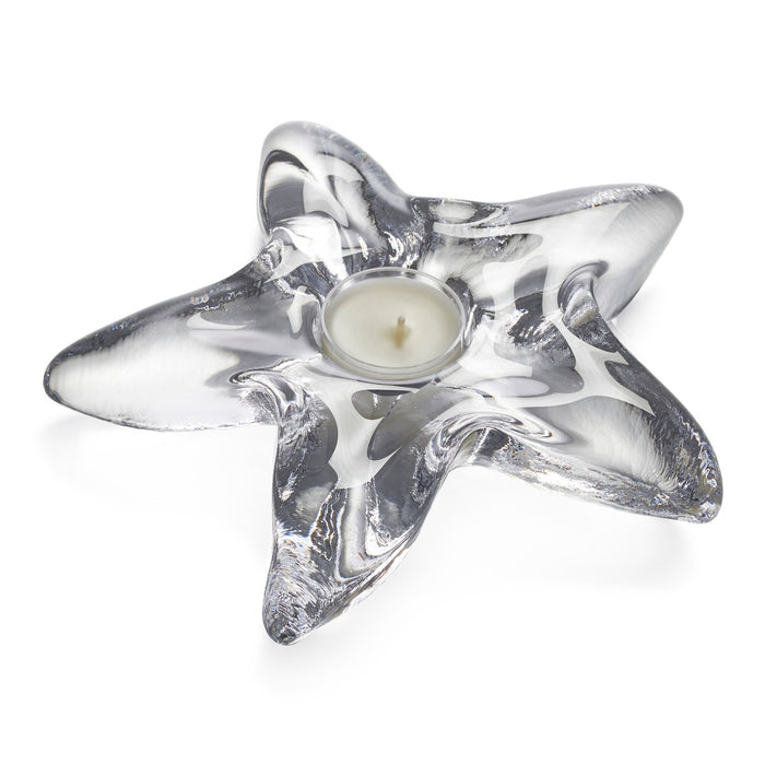 Silver starfish-shaped holder with cream tealight candle in center glass cup.