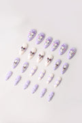 Purple press-on nails with Kewpie character and bow designs