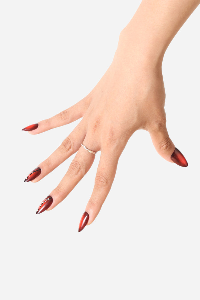 STRAP TEASE almond press-on nails with crimson gradient and crystal accents