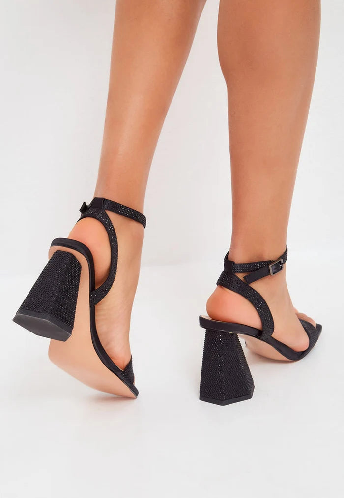 A stylish pair of strappy black block heel sandals embellished with dazzling rhinestones - the perfect women's footwear for any special occasion.