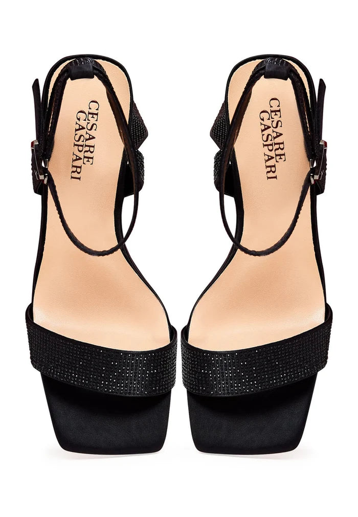 A stylish pair of black block heel strappy sandals featuring sparkling rhinestones, perfect for adding a touch of elegance to any outfit. Trendy women's footwear for any occasion.