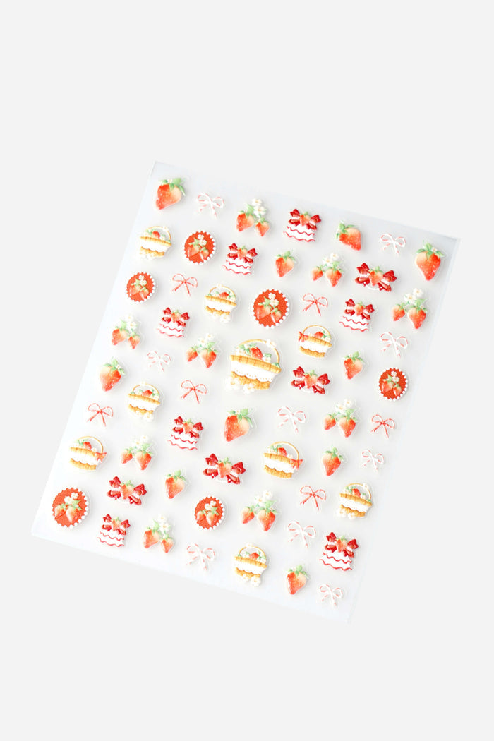 Sheet of cute strawberry and bow nail stickers with 3D embossed designs.