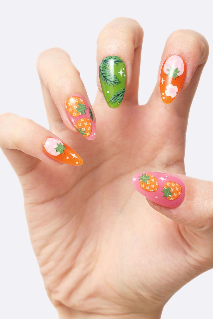 Strawberry Patch press-on nails with floral and fruit designs.
