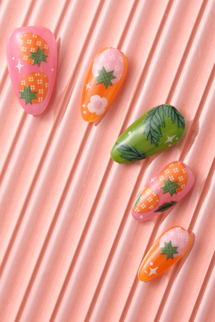 Strawberry Patch by Megan Roy press-on nails with assorted fruit and leaf designs.
