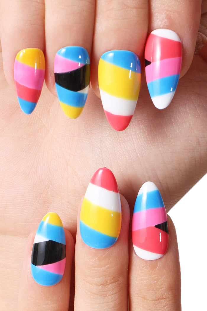 Press-on nails with a colorful striped design featuring pink, blue, yellow, black, and white sections.