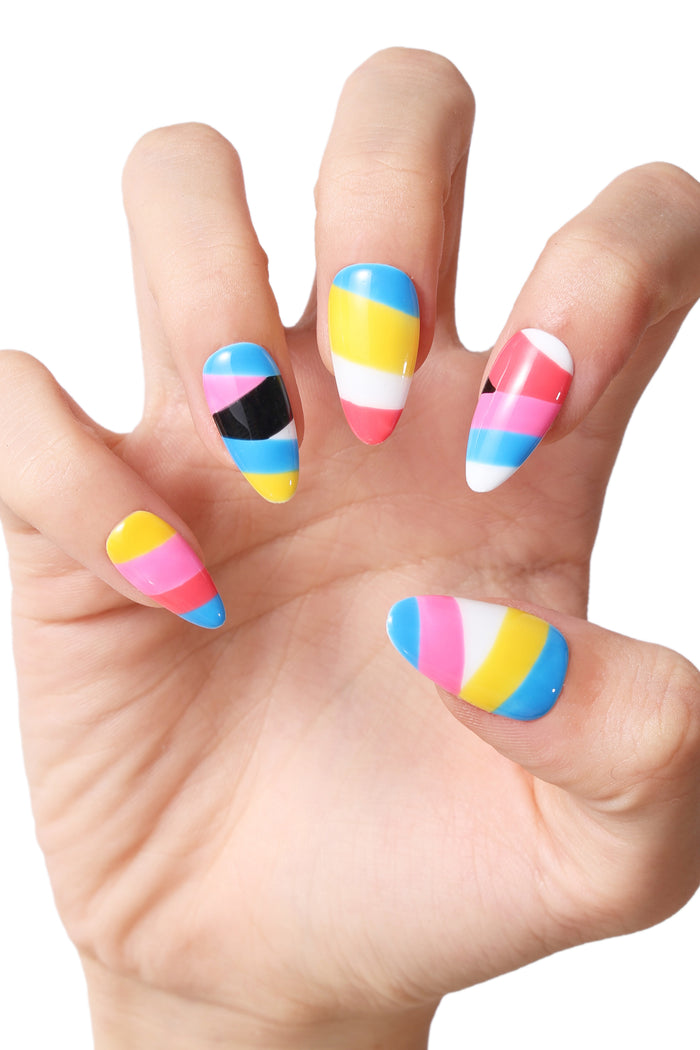 Striped Bliss press-on nails featuring bold stripes of pink, yellow, blue, white, and black.