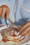 Light blue almond press-ons with Snoopy and stars, cutting into pancakes.