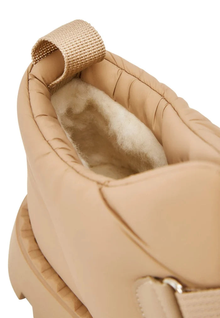 A pair of cozy beige suede winter boots with wool lining, perfect for cold weather.