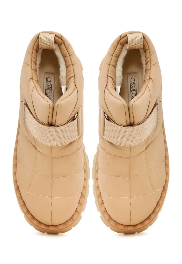 A pair of stylish beige suede winter boots with cozy wool lining, perfect for cold weather footwear.