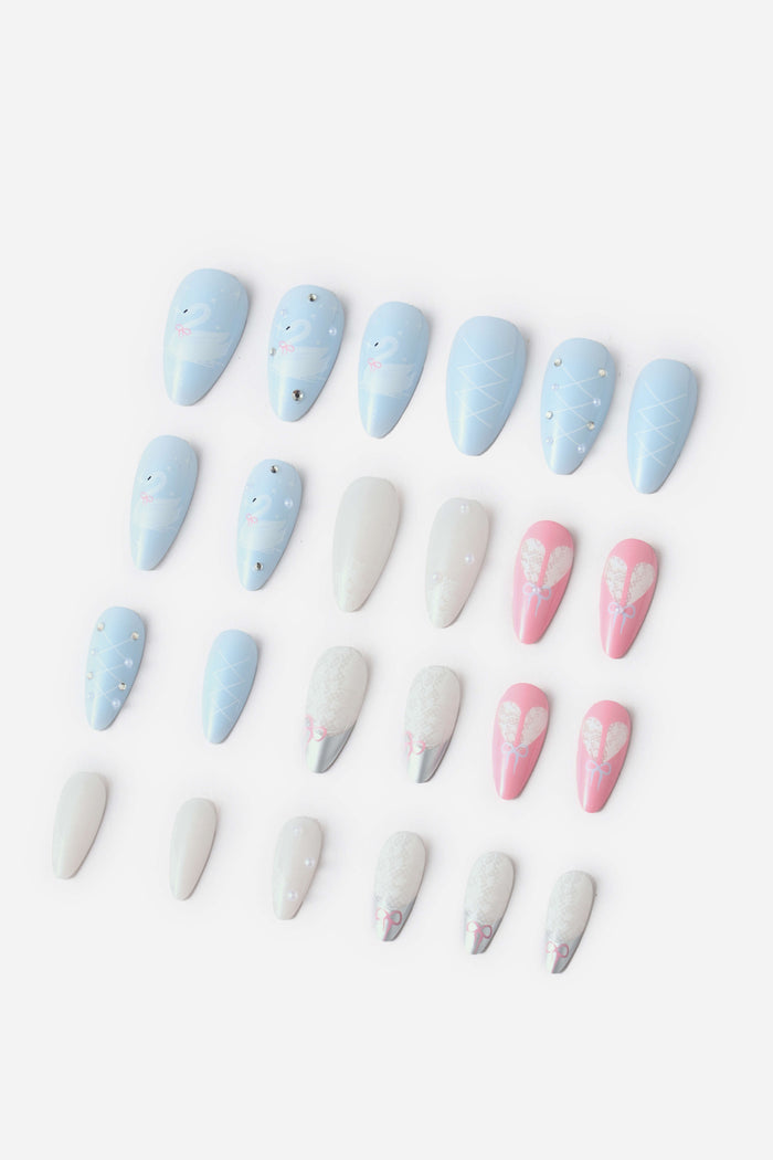 Almond press-on nails with pastel blue, white, and pink designs featuring swans, pearls, lace, and bows.