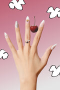 Almond press-on nails featuring Snoopy and Woodstock designs, with pastel swirls and a cherry accent.