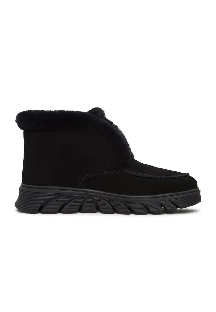 Stylish taupe shearling-lined ankle boots, also known as Adriana black boots, a trendy choice for cold weather outfits.