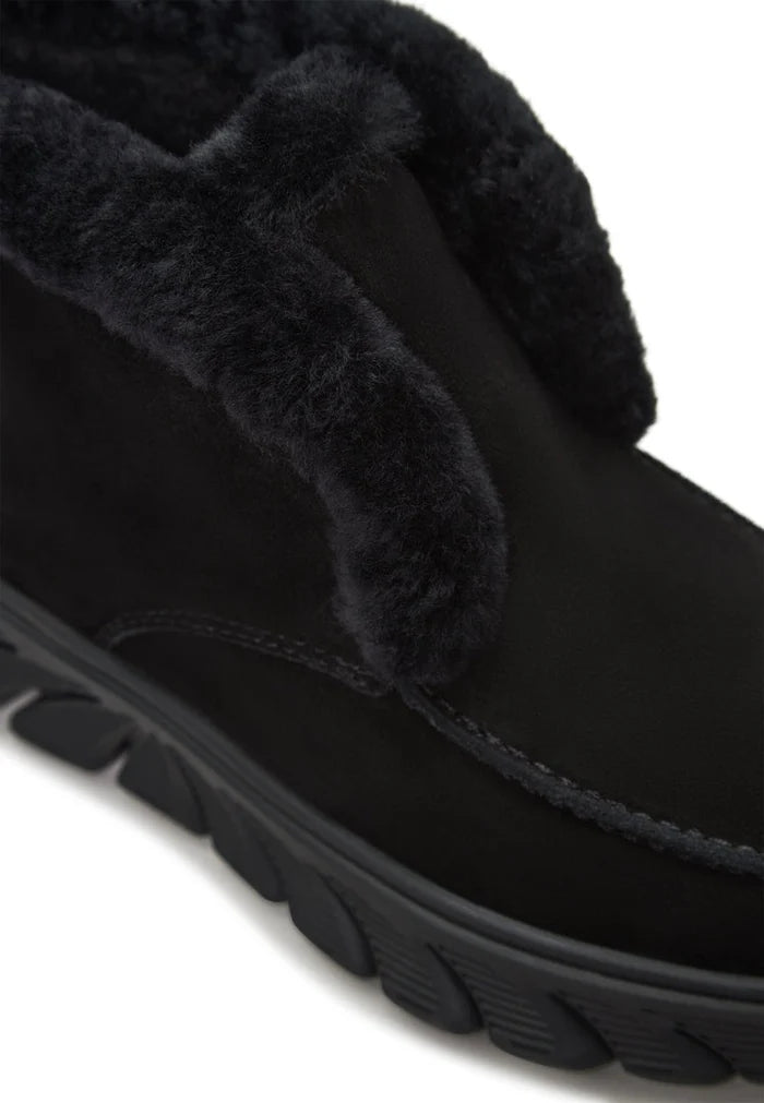 A stylish pair of taupe shearling-lined ankle boots similar to the Adriana black boots, perfect for staying warm and fashionable this winter.